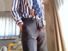 Gay Asian man in business attire pleasuring himself in video.